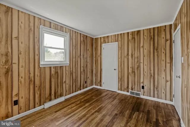 a view of a room with wooden floor and windows