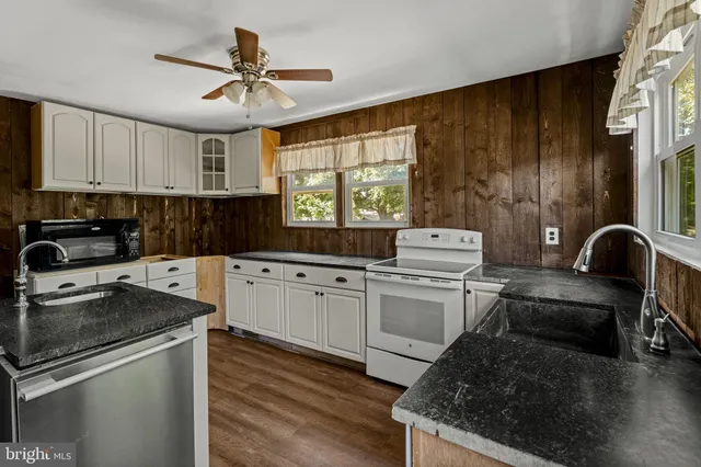 a kitchen with a stove cabinets and a refrigerator