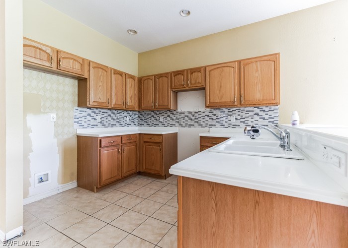 8981 Falcon Pointe Loop Fort Myers, FL 33912 - Photo 11 of 25 a kitchen with a sink stove and cabinets