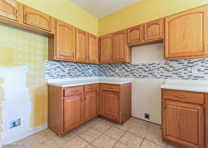 8981 Falcon Pointe Loop Fort Myers, FL 33912 - Photo 12 of 25 a kitchen with granite countertop cabinets sink and granite counter tops