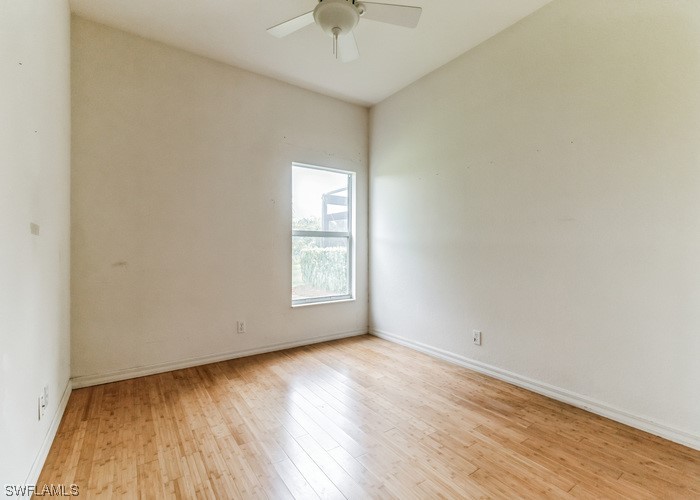 8981 Falcon Pointe Loop Fort Myers, FL 33912 - Photo 17 of 25 an empty room with wooden floor and windows