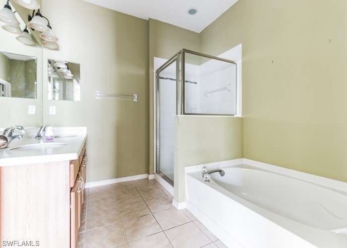 8981 Falcon Pointe Loop Fort Myers, FL 33912 - Photo 24 of 25 a spacious bathroom with a tub sink and mirror