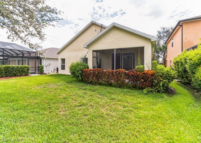 8981 Falcon Pointe Loop Fort Myers, FL 33912 - Photo 3 of 25 a view of a house with a yard and plants