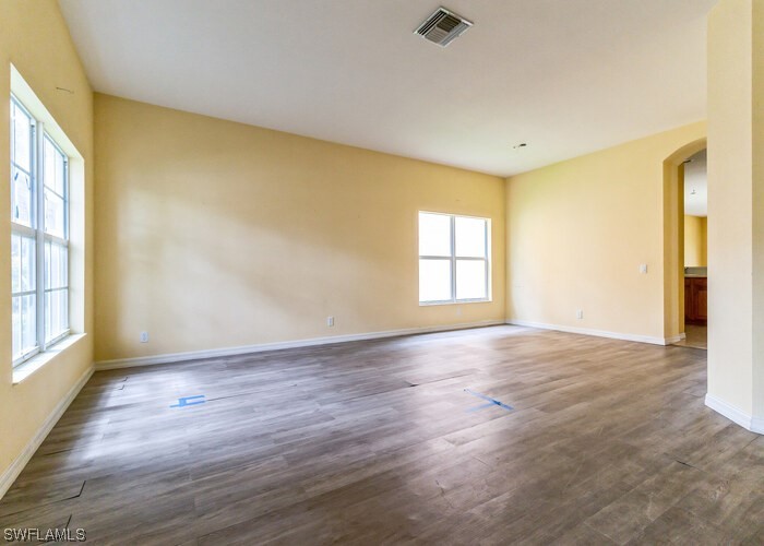 8981 Falcon Pointe Loop Fort Myers, FL 33912 - Photo 6 of 25 a view of an empty room with wooden floor and a window