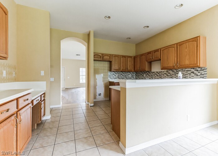 8981 Falcon Pointe Loop Fort Myers, FL 33912 - Photo 10 of 25 a kitchen with a stove a refrigerator and a sink