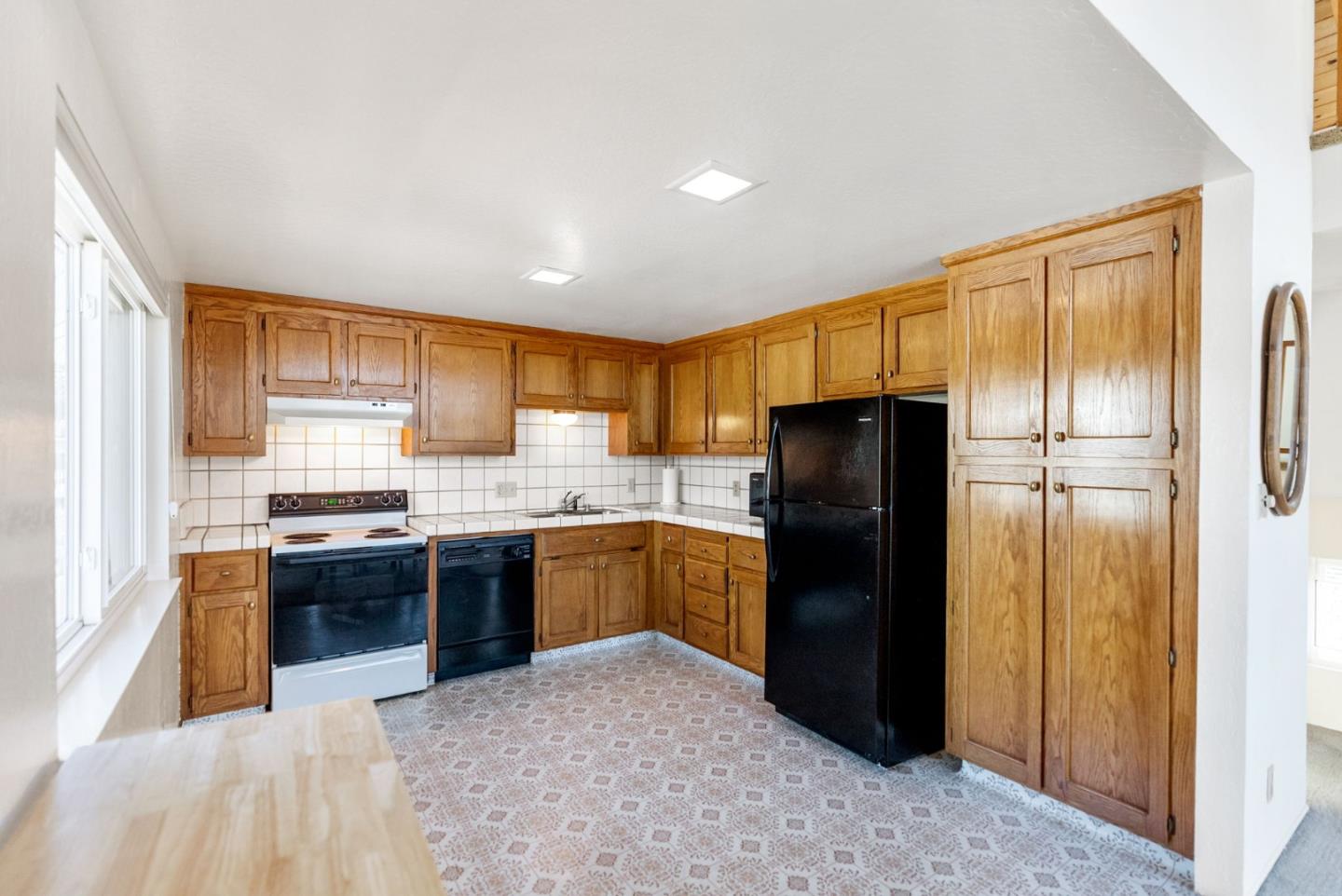 135 Stephen Road Aptos, CA 95003 - Photo 16 of 44 a kitchen with stainless steel appliances granite countertop a refrigerator and a stove top oven