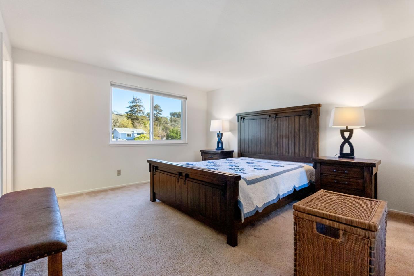 135 Stephen Road Aptos, CA 95003 - Photo 22 of 44 a bedroom with a bed and a lamp on dresser