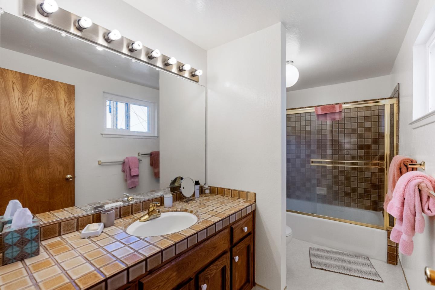 135 Stephen Road Aptos, CA 95003 - Photo 23 of 44 a bathroom with a granite countertop sink and a mirror