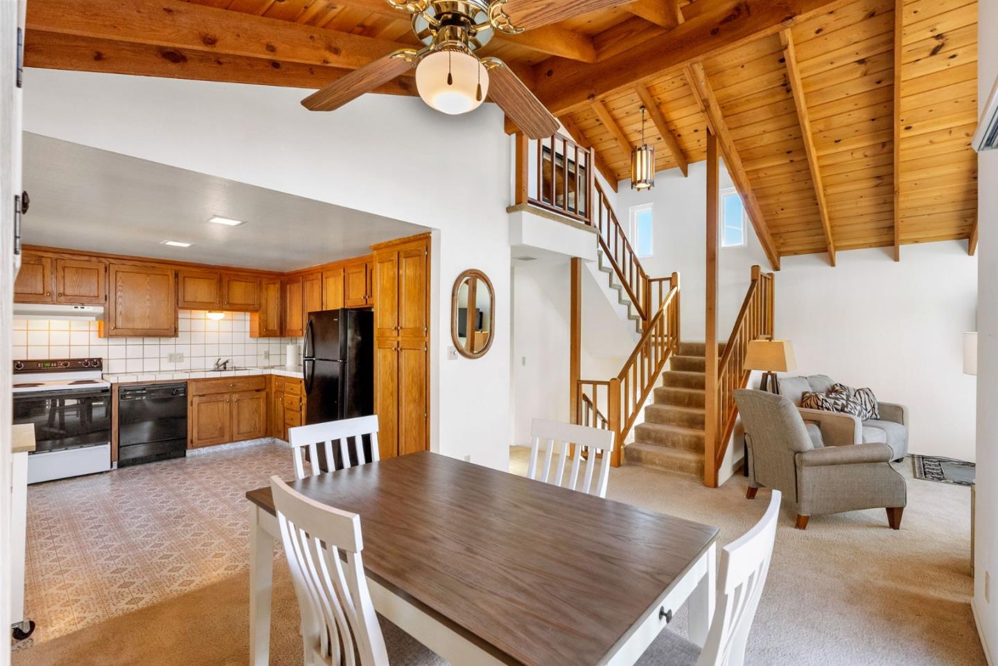 135 Stephen Road Aptos, CA 95003 - Photo 5 of 44 a dining hall with stainless steel appliances kitchen island granite countertop a table chairs and couches