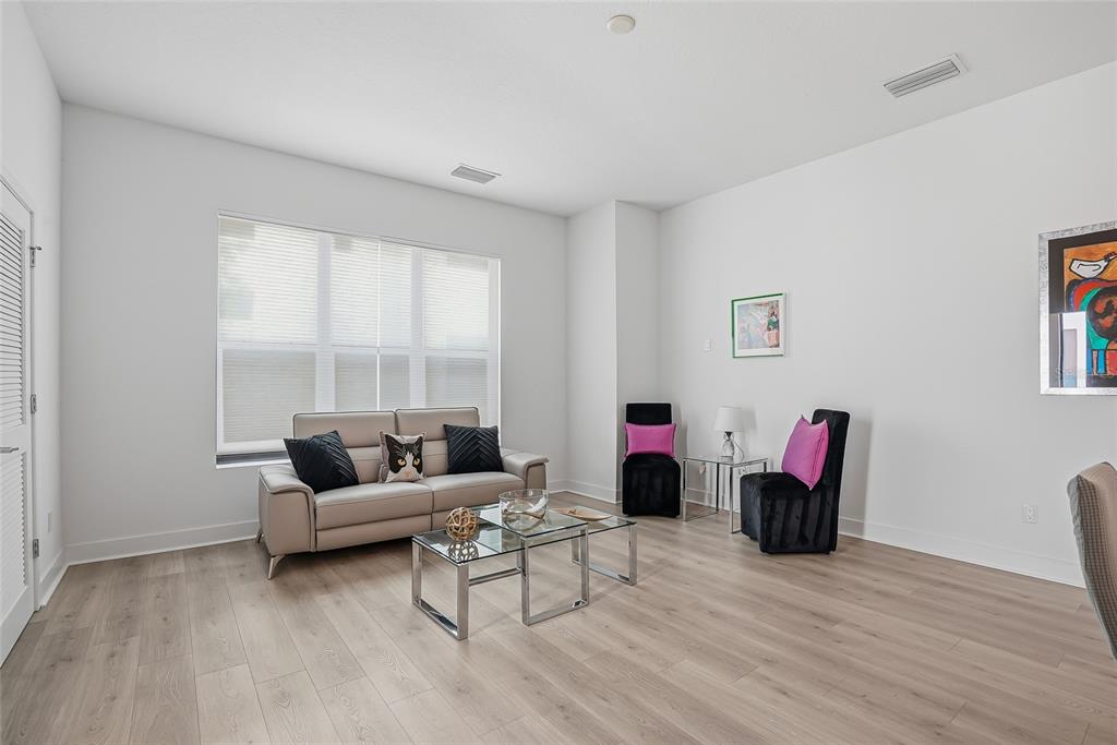 4810 West McElroy Avenue, Unit 30 Tampa, FL 33611 - Photo 13 of 43 a living room with furniture and a wooden floor