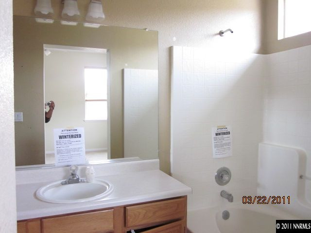 3025 Andrea Street Reno, NV 89503 - Photo 7 of 11 a bathroom with a sink and a mirror