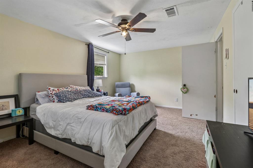 820 North Bowen Road Arlington, TX 76012 - Photo 22 of 40 a bedroom with a bed and window