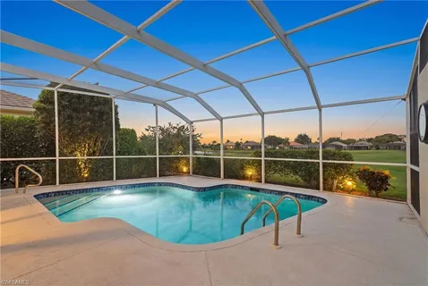 a view of a backyard with a swimming pool