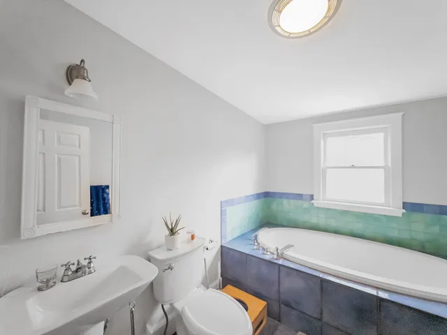 a bathroom with a sink a toilet and tub