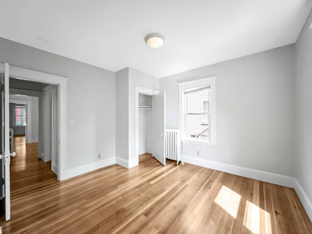 a view of a livingroom with wooden floor and a window