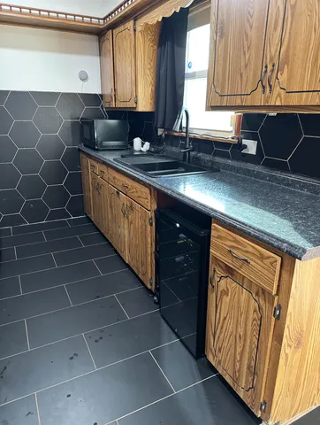 a kitchen with a sink stove and cabinets