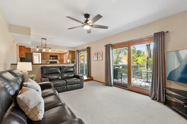 a living room with furniture ceiling fan and a window