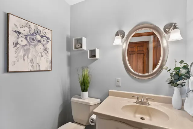 a bathroom with a toilet a sink and a mirror