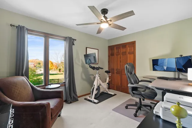 a view of a livingroom with workspace and a window