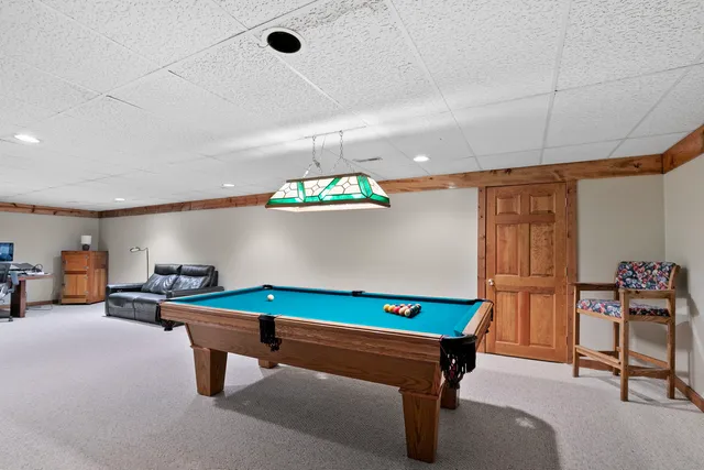 a room with furniture and pool table