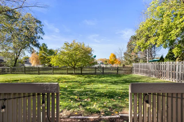 a view of a deck and a yard with green space