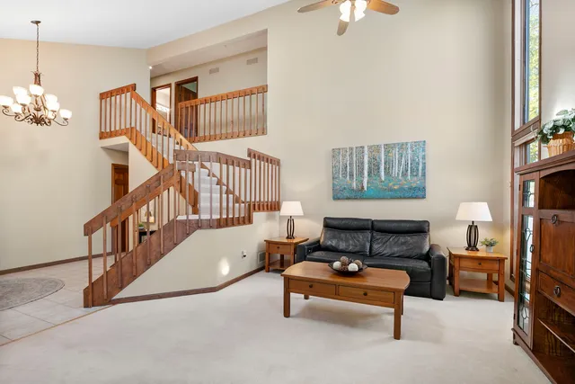 a living room with furniture a rug and a chandelier
