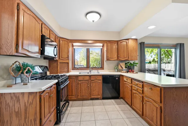 a kitchen with a sink stove top oven and cabinets