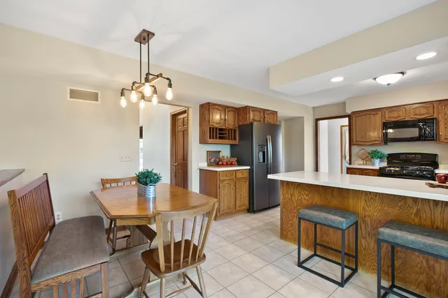a view of a dining room with furniture and chandelier