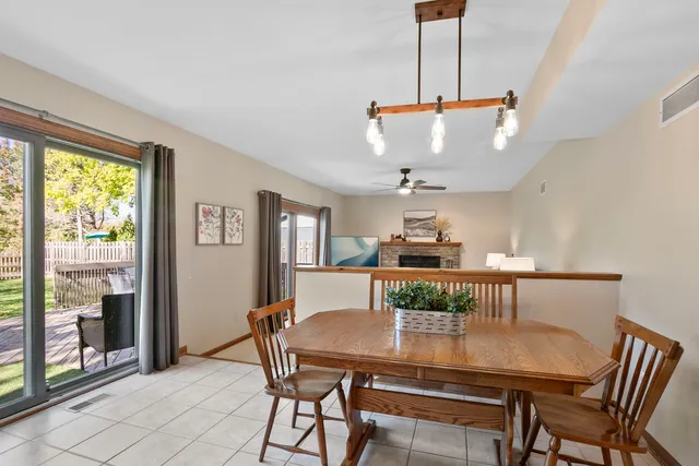 a view of a dining room with furniture and a chandelier