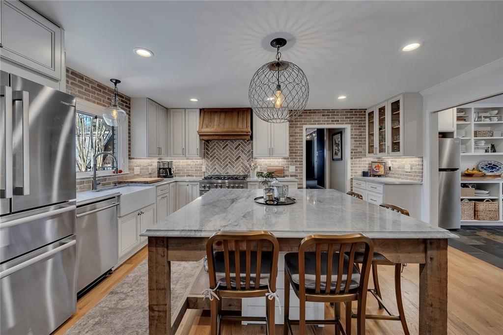 1424 Ridgeway Drive Northwest Acworth, GA 30102 - Photo 11 of 38 a kitchen with stainless steel appliances granite countertop a kitchen island and chairs in it