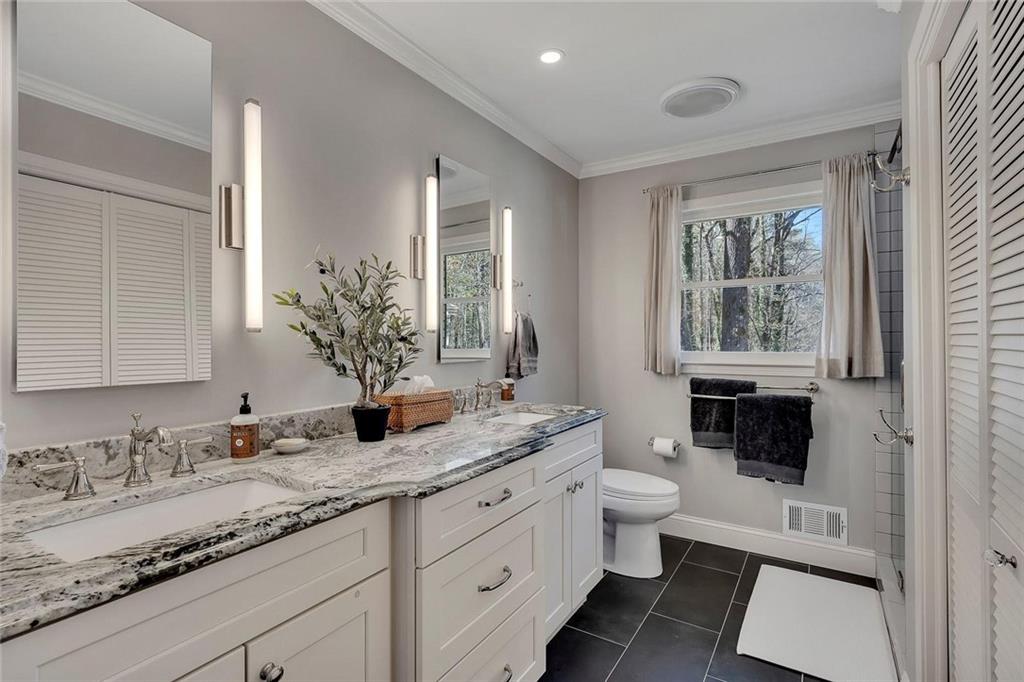 1424 Ridgeway Drive Northwest Acworth, GA 30102 - Photo 23 of 38 a bathroom with a granite countertop sink mirror vanity and toilet