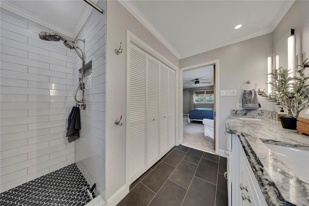 1424 Ridgeway Drive Northwest Acworth, GA 30102 - Photo 25 of 38 a bathroom with a granite countertop sink a mirror and shower