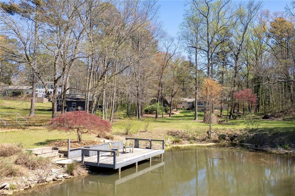 1424 Ridgeway Drive Northwest Acworth, GA 30102 - Photo 34 of 38 a view of a lake with chairs and a yard