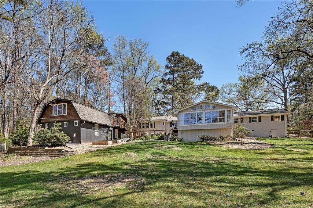 1424 Ridgeway Drive Northwest Acworth, GA 30102 - Photo 4 of 38 a front view of a house with a garden and trees