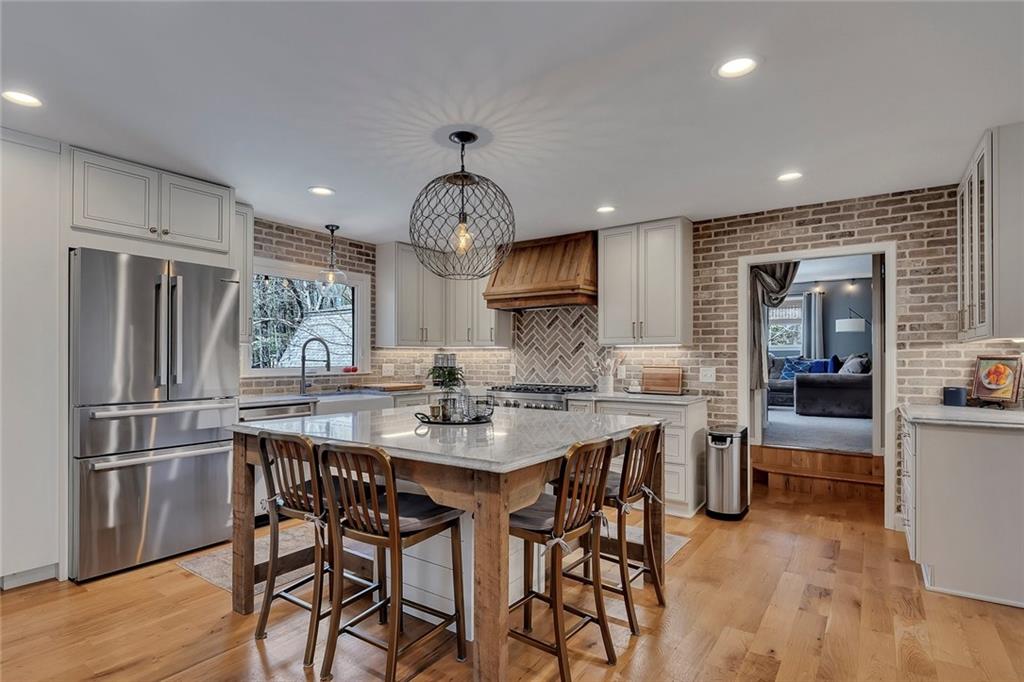 1424 Ridgeway Drive Northwest Acworth, GA 30102 - Photo 10 of 38 a kitchen with stainless steel appliances a dining table chairs stove and refrigerator
