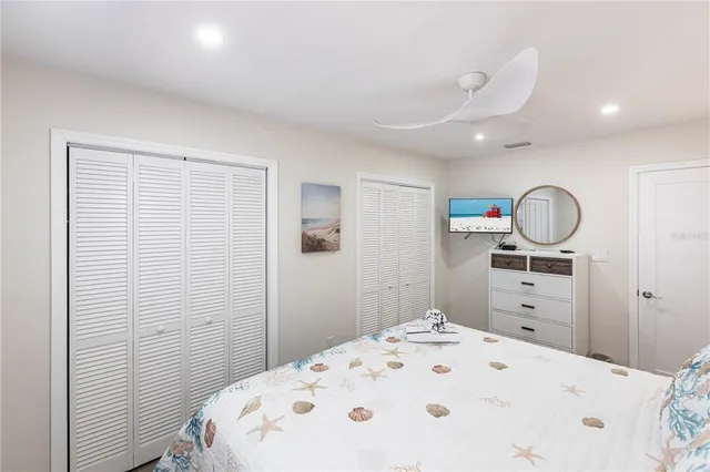 a bedroom with a bed and cabinets