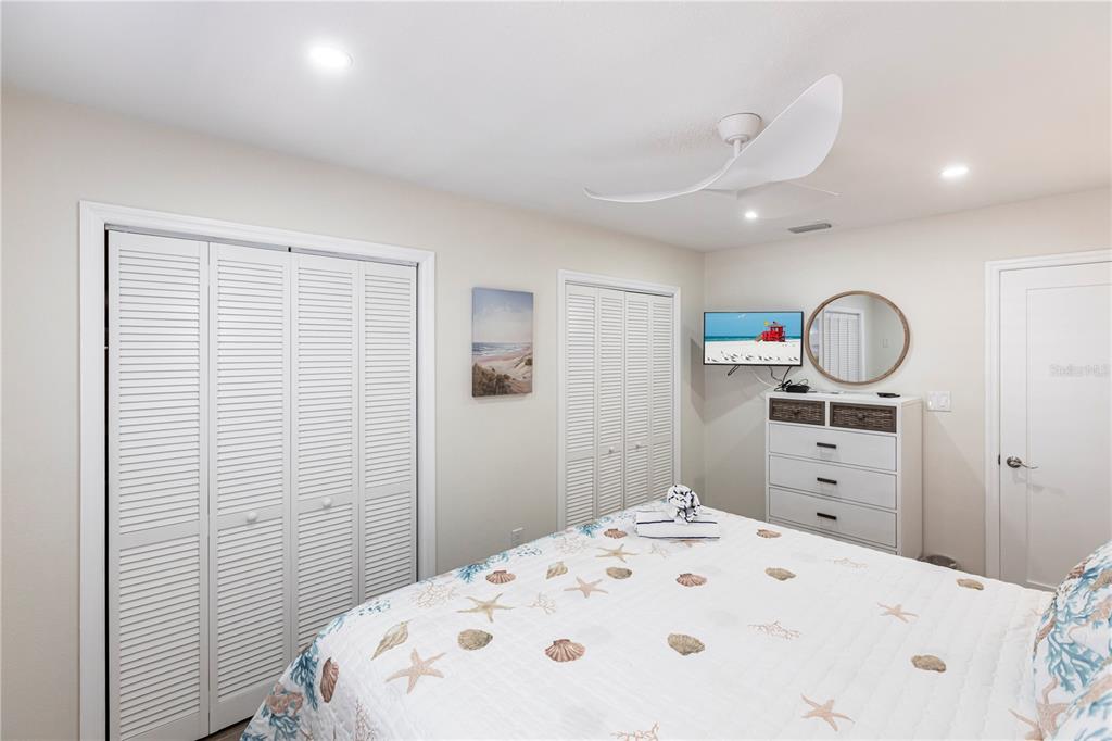 6020 Midnight Pass Road, Unit 29 Sarasota, FL 34242 - Photo 12 of 16 a bedroom with a bed and cabinets
