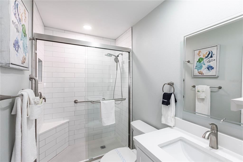 6020 Midnight Pass Road, Unit 29 Sarasota, FL 34242 - Photo 14 of 16 a bathroom with a sink toilet and shower