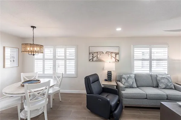 a living room with furniture and a chandelier