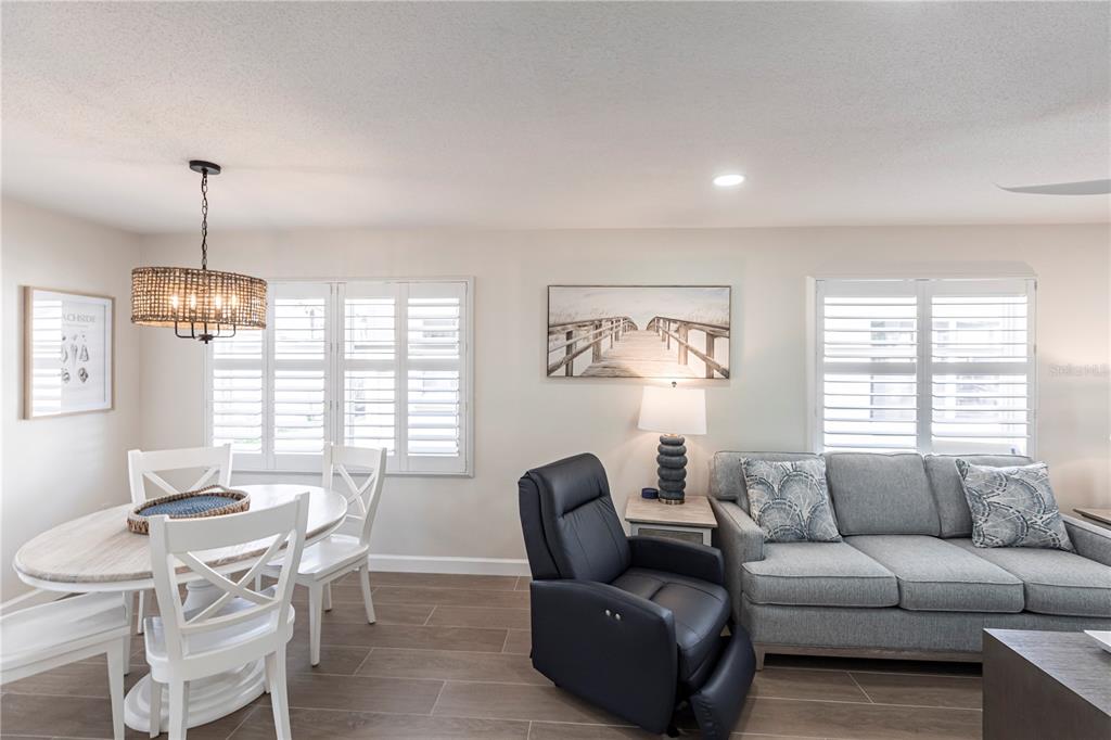 6020 Midnight Pass Road, Unit 29 Sarasota, FL 34242 - Photo 5 of 16 a living room with furniture and a chandelier