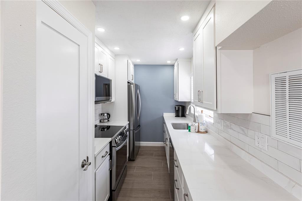 6020 Midnight Pass Road, Unit 29 Sarasota, FL 34242 - Photo 6 of 16 a kitchen with refrigerator a sink and a refrigerator