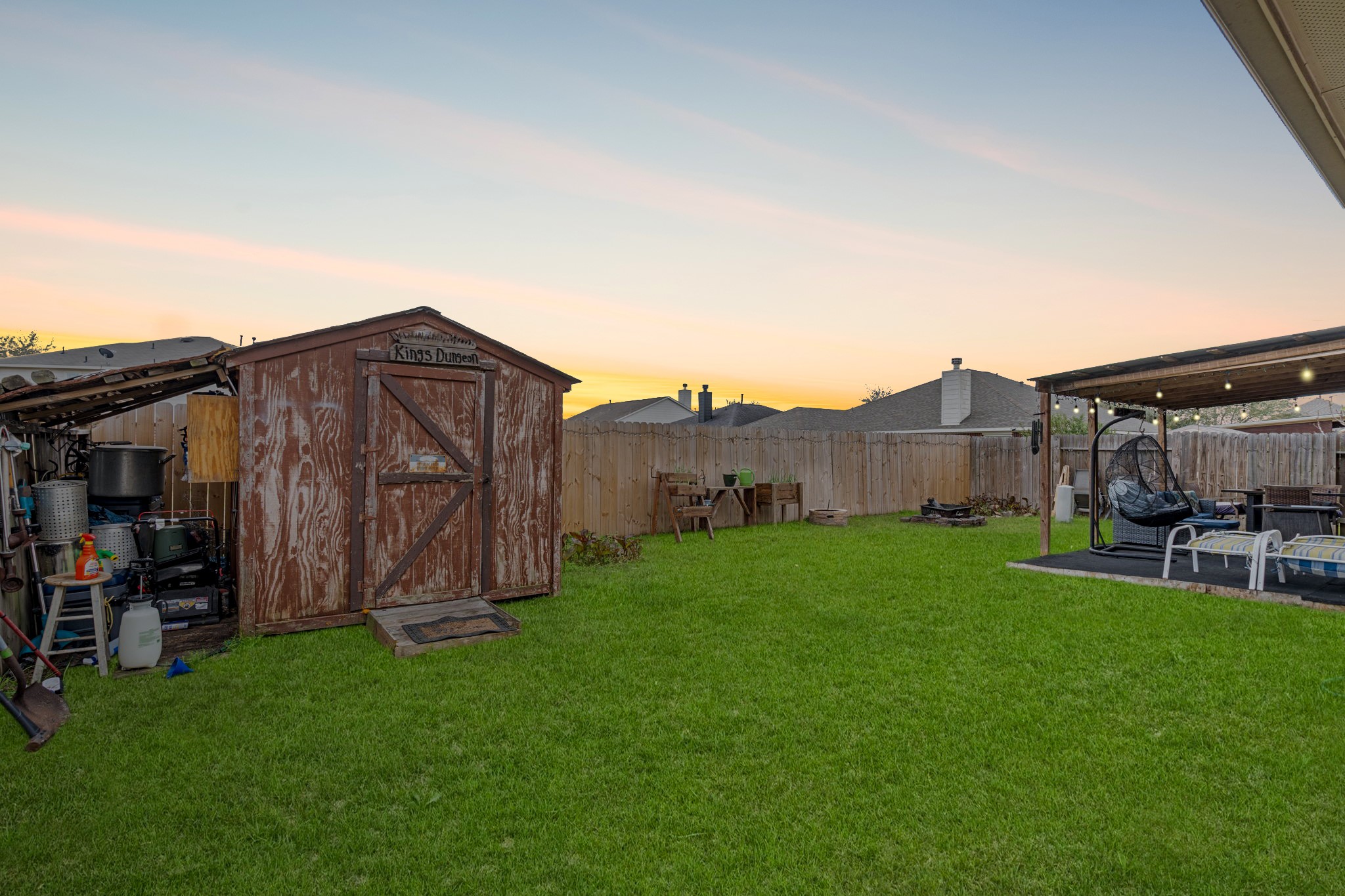 1319 Collier Point Lane Fresno, TX 77545 - Photo 28 of 33 The spacious backyard features a lush green lawn and a convenient storage shed, offering both functionality and room to play or garden.