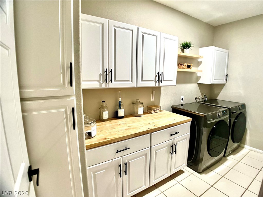 2050 West Warm Springs Road, Unit 321 Henderson, NV 89014 - Photo 14 of 28 This laundry area features contemporary appliances and ample storage space.