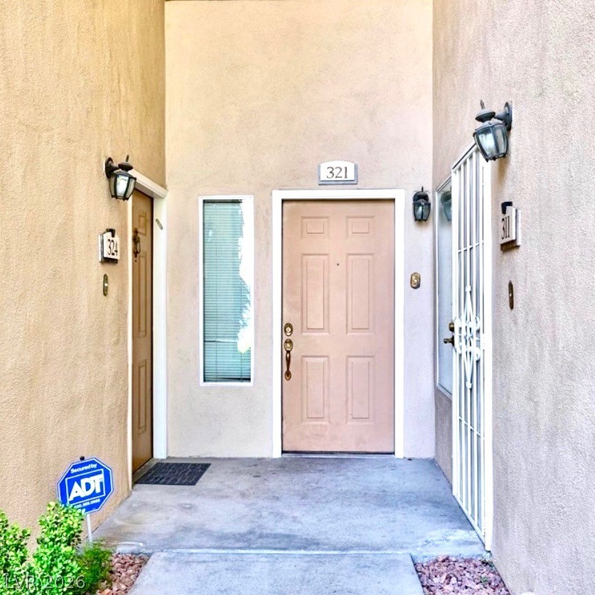 2050 West Warm Springs Road, Unit 321 Henderson, NV 89014 - Photo 23 of 28 This inviting entrance features traditional outdoor lighting and a well-maintained pathway.