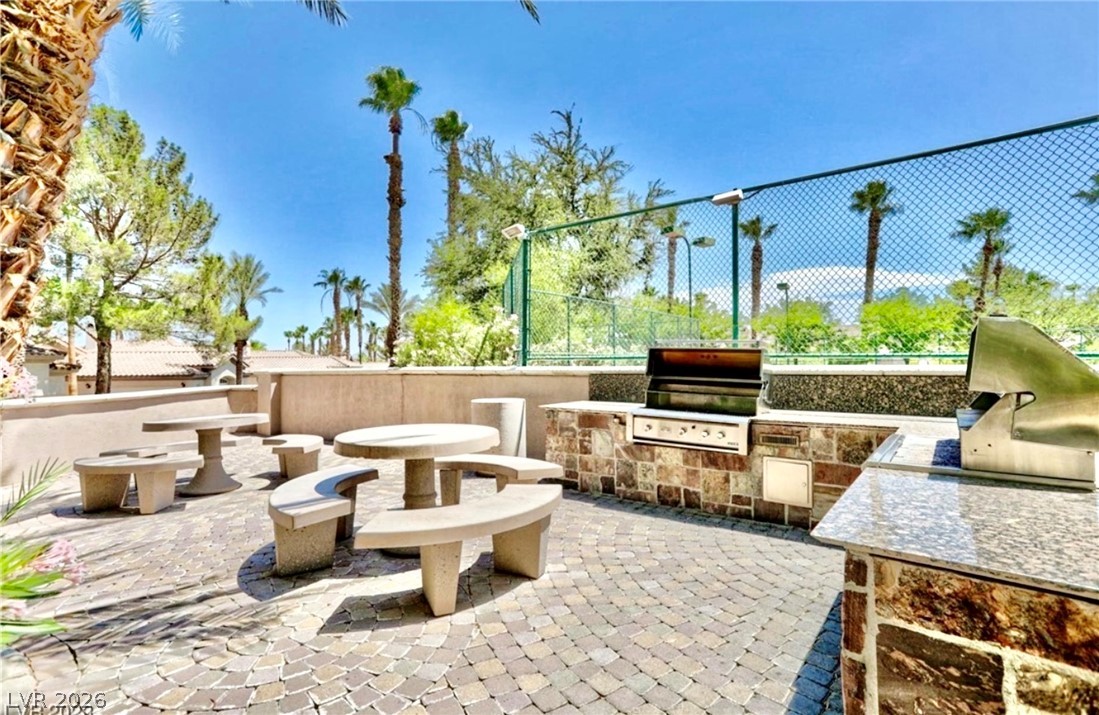 2050 West Warm Springs Road, Unit 321 Henderson, NV 89014 - Photo 24 of 28 Enjoy outdoor gatherings with dedicated barbecue and ample seating on this inviting patio.