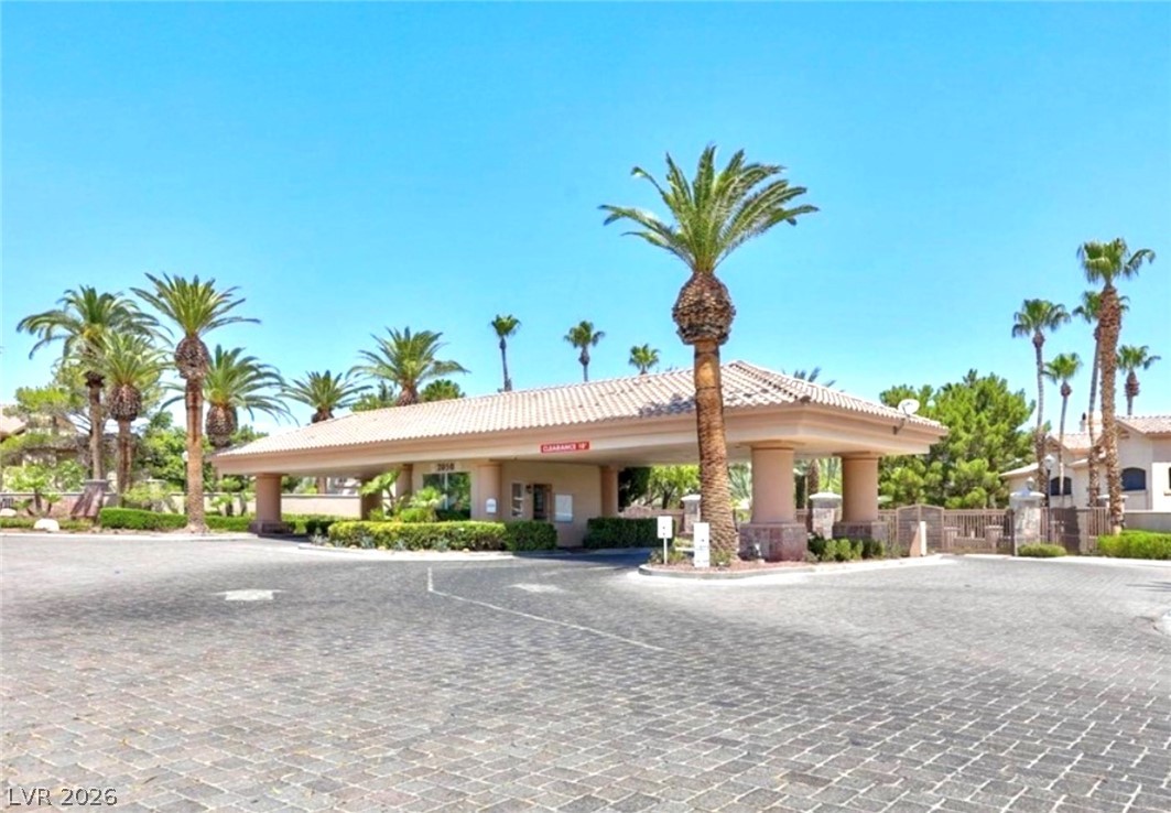 2050 West Warm Springs Road, Unit 321 Henderson, NV 89014 - Photo 28 of 28 This grand entrance features a tiled roof and lush landscaping, welcoming all who enter this vibrant community.