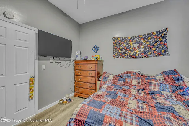 a bedroom with a bed and a television