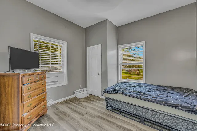 a living room with furniture flat screen tv and a window
