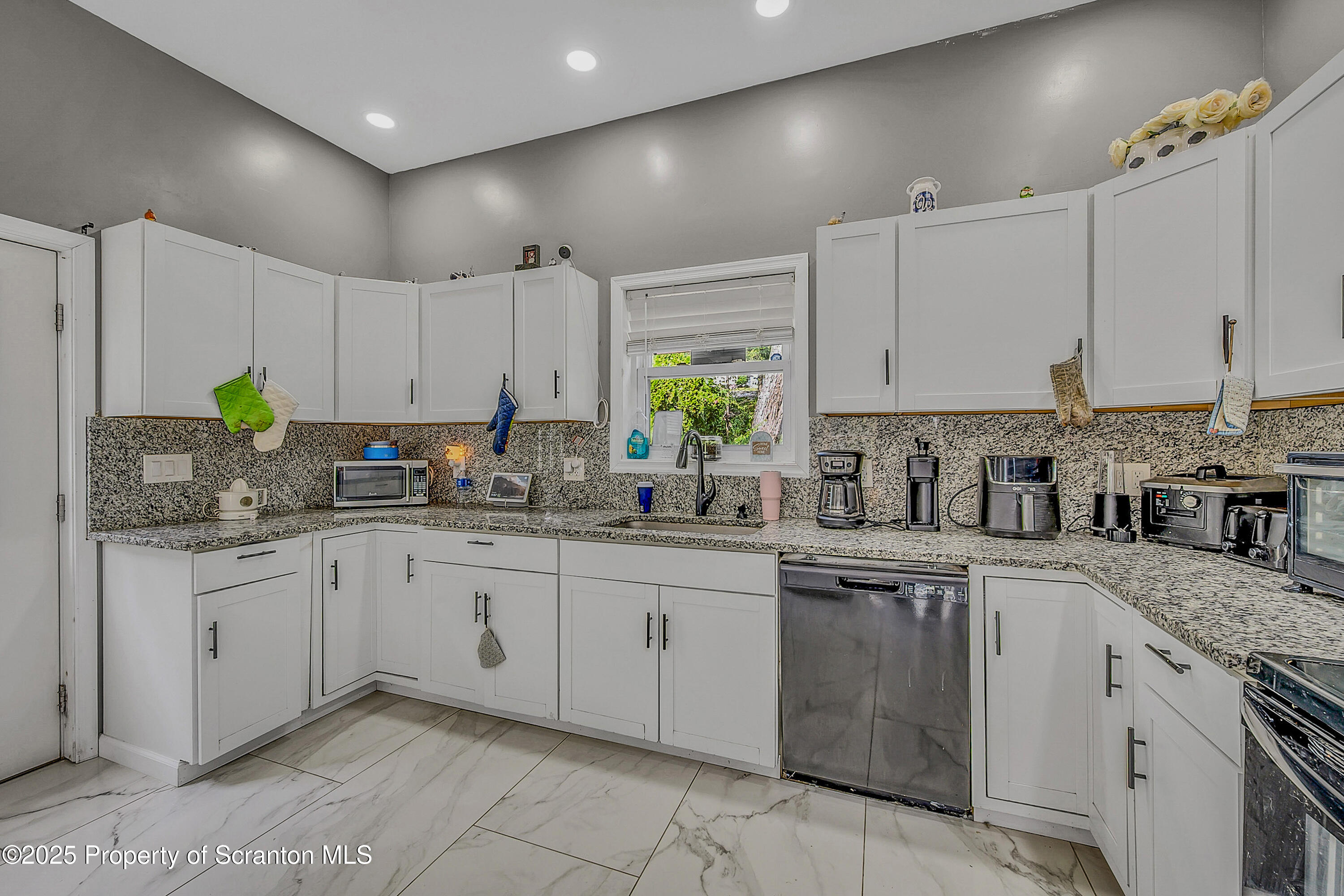 37 Mount Pocono Court Mount Pocono, PA 18344 - Photo 10 of 39 a kitchen with granite countertop cabinets stainless steel appliances a sink and a window