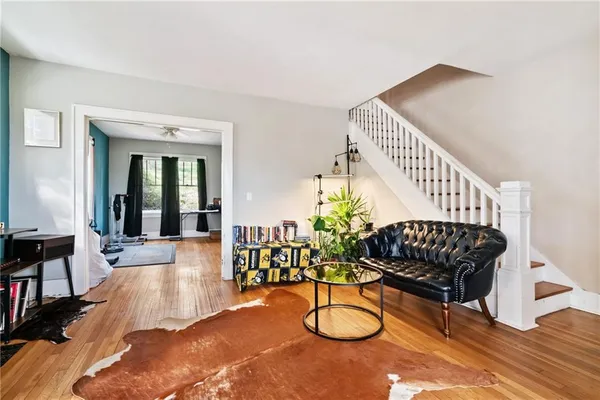 a living room with furniture and wooden floor